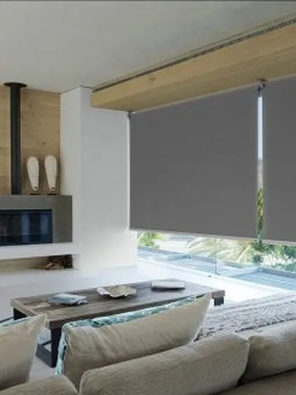 Here are my sleek, grey roller blinds installed in a modern living room. They offer excellent light control and a minimalist aesthetic that complements contemporary furniture and open-plan layouts.