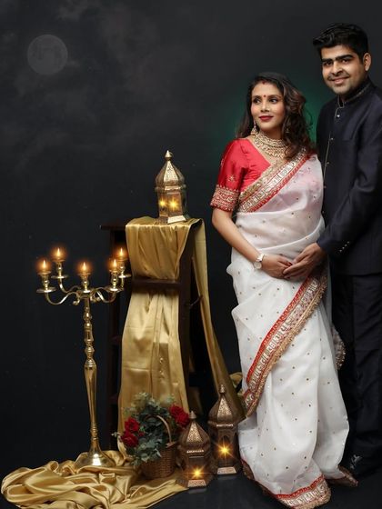 A romantic, moonlit version of a traditional portrait. This couple looks timeless in their ethnic wear, set against a backdrop that adds a touch of magic.