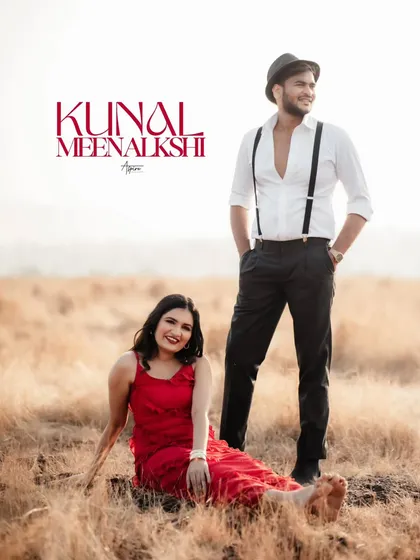 A stylish portrait of Kunal and Meenakshi in a golden field. Her vibrant red dress contrasts beautifully with the rustic setting, while his relaxed pose adds a touch of classic charm.