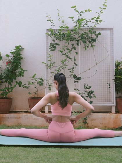 Working on a side split, a prep pose for Bhoomasana. This asana provides a deep stretch for the inner thighs and hamstrings, significantly increasing lower body flexibility over time.