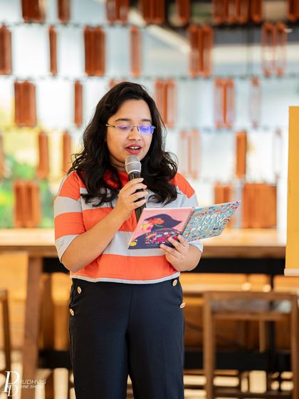 A young poet reads from her book, bravely sharing her perspective on vulnerability.