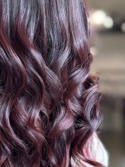 A close-up on the dreamy burgundy waves, capturing the glossy finish and rich color.