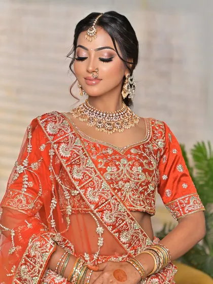 This shot showcases the full neckline and how the jewellery sits against the embroidered blouse. You can also see the matching earrings and the stack of bangles that complete this traditional bridal look.