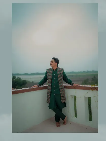 This wide-angle shot captures the groom in his stylish Haldi outfit, posing against a scenic, hazy backdrop. It's an artistic portrait that feels both modern and timeless.