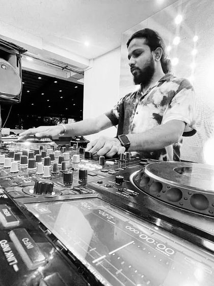 Focused on the mix. This black and white shot captures the concentration it takes to blend tracks perfectly and keep the energy flowing.