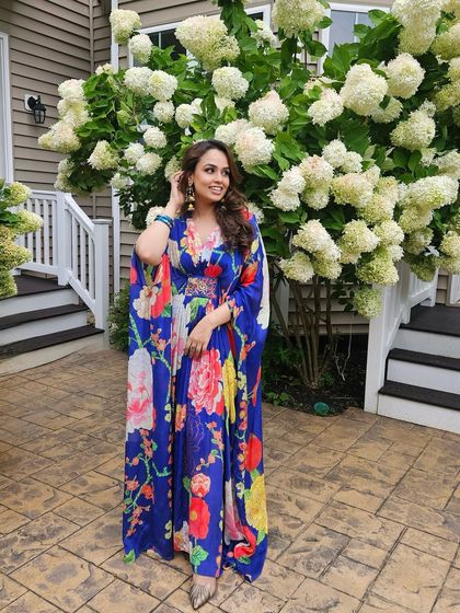 Mehendi vibes in a floral kaftan. The makeup for this look was fresh and breezy, with a focus on glowing skin and a soft eye to match the daytime festivities.