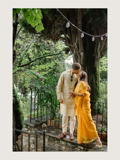 A romantic kiss on a stone staircase. This shot combines the intimacy of the couple with the rustic charm of their Italian wedding venue.