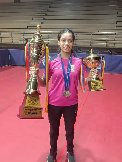 Ananya Chande holding her winner and runner-up trophies from the SGFI games. This image perfectly captures the scale of her achievement at this prestigious national school tournament.