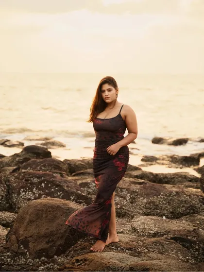 A golden hour portrait session on a rocky Mumbai beach. I focused on using the soft, warm light of the sunset to capture a natural and relaxed moment against the sea.