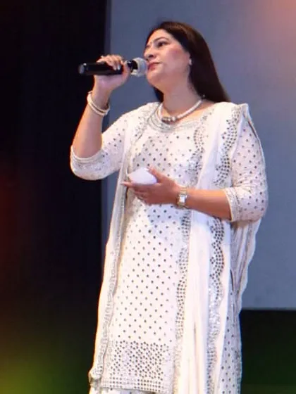 A confident vocal student takes the stage with the microphone at our annual showcase. I prepare students not just in technique but also in stage presence, helping them connect with their audience.