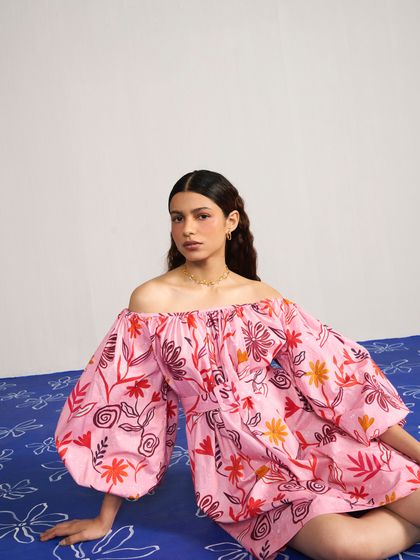 Styling and direction for Joskai Studio, featuring a vibrant pink off-the-shoulder dress. The custom-painted floor adds a playful and artistic element to the shoot.