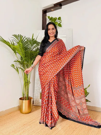 This rust-orange printed crepe saree adds a pop of color to your work wardrobe. The fabric is comfortable for all-day wear and doesn't require special care.