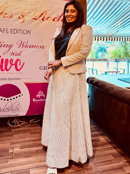 Standing by the banner of an event celebrating women. It's a powerful reminder to keep pushing, keep winning, and keep supporting each other.
