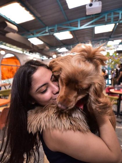 A guest gives a happy cocker spaniel a big hug. It's impossible not to smile when you're here.