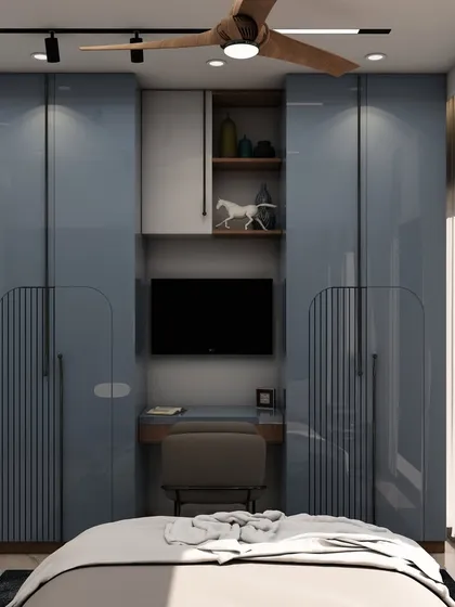 The opposite wall of the same bedroom showcases a clever wardrobe design with an integrated TV unit and study desk, a perfect space-saving solution for modern apartments.