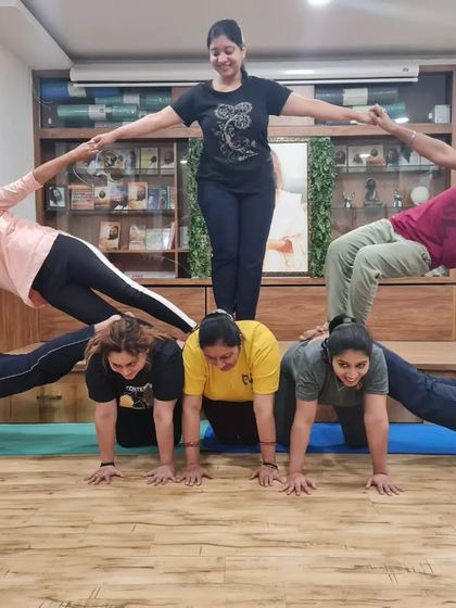 Another creative and fun group acro yoga pose. This human pyramid is built on trust, communication, and a lot of smiles.