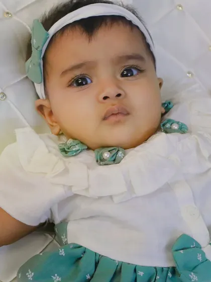 Another beautiful portrait of my niece, showing the details of her adorable ruffled outfit and headband. These photos are perfect for baby announcements or family albums.