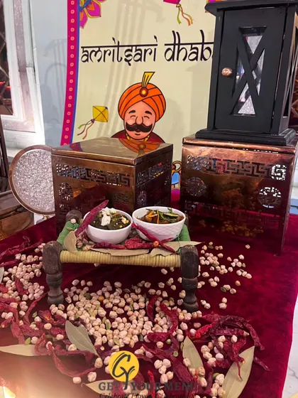 Our Amritsari Dhaba themed setup, using miniature charpais and scattered chickpeas and chillies for an authentic and rustic feel.