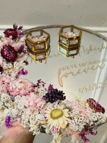 A unique take on the ring platter, this 'Moonflora' design uses a mirror base to reflect the beautiful arrangement of dried flowers. The custom quote 'We've decided on forever' adds a personal touch.
