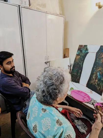 A glimpse into our one-on-one mentorship. Our instructor provides guidance to Harinder ma'am as she works on her large-scale waterfall canvas.
