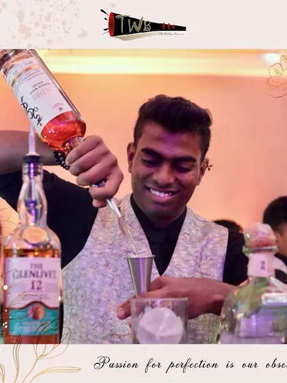 A smiling bartender prepares a drink, reflecting the positive and engaging attitude of our team.