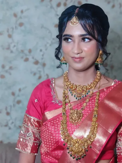 Ankita's wedding look in a stunning red Kanjeevaram saree, with soft makeup and a classic bridal updo.