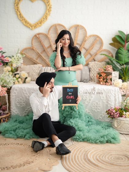 A fun and playful moment from their session. The couple wonders "Boy or Girl?" with a chalkboard prop, adding a touch of lighthearted fun to their maternity portraits.