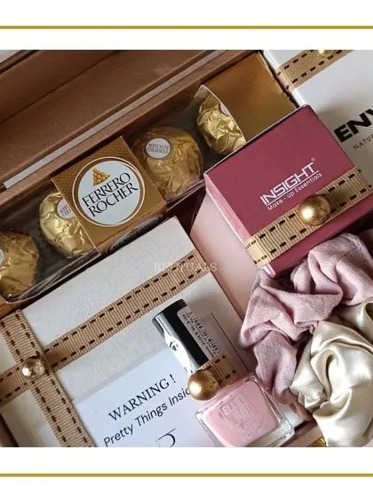 A closer look inside the wedding hamper, showing the arrangement of Ferrero Rocher, Insight cosmetics, and a satin scrunchie.