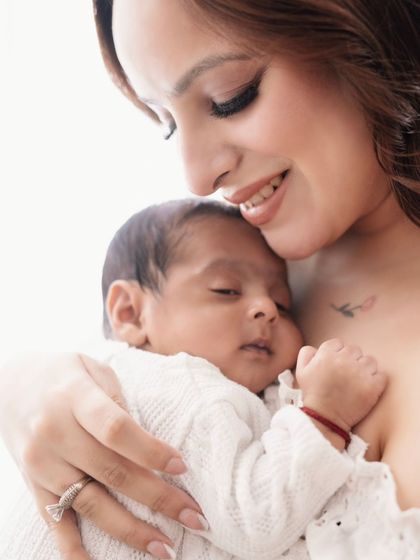 There is no safer place than in a mother's arms. This close-up shot captures the warmth and security of a mother's embrace.