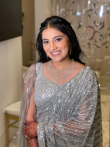 Mishika looking absolutely stunning for her reception. I kept her makeup soft and glowing to complement her sparkling silver saree, creating a look of understated elegance.