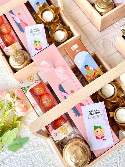 A closer look inside our Ganesh Chaturthi hamper, showing the motichoor laddoos and lotus-shaped diyas.