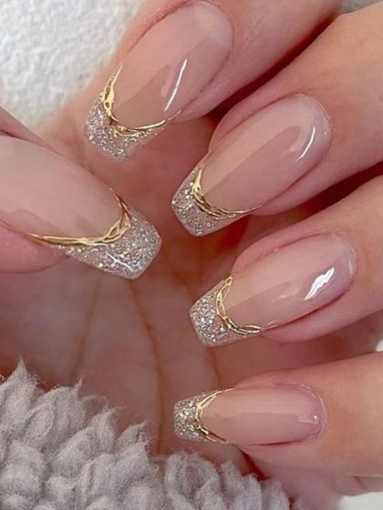Elegant wedding nails for a sophisticated look. This design features a classic square shape with a delicate gold and silver glitter French tip.