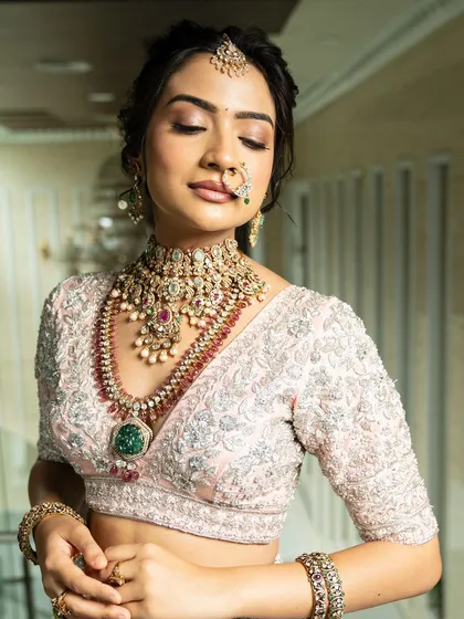 Twirl into a fairytale with this baby pink bridal lehenga. I designed it with intricate horse embroidery on the raw silk skirt and paired it with a heavily handworked blouse and a delicate net dupatta for a truly heavenly look.