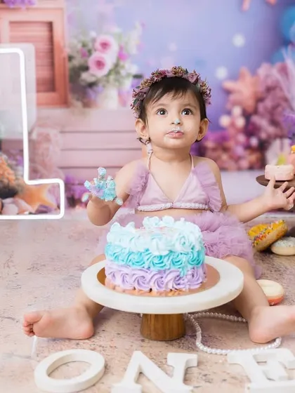 Getting ready for a magical underwater adventure with this mermaid-themed first birthday cake smash. The pastel colors and sea-themed props create such a dreamy scene.