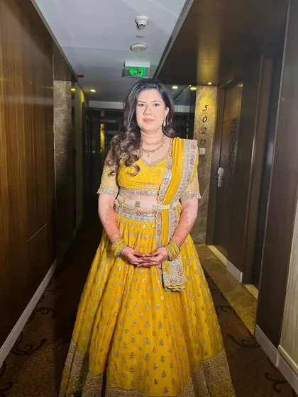 A full-length view of this soft and glowing minimalistic look. The yellow lehenga is perfect for a daytime event, and the makeup is fresh and light.