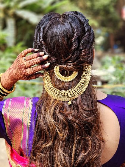 A creative way to accessorize hair for pre-wedding rituals. We used a traditional gold necklace as a hairpiece to create this unique and stunning look.