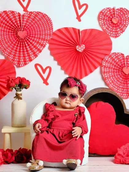 This little diva is rocking her heart-shaped sunglasses in our Valentine's Day setup. Adding fun accessories is a great way to bring out a child's personality.