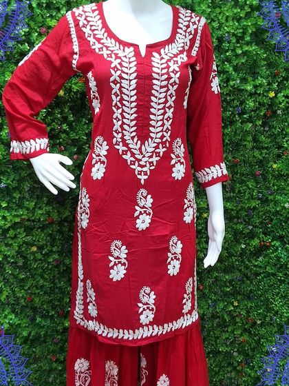 A vibrant red kurti with dense white Chikankari work around the neckline and scattered motifs all over. This piece can be stitched to your measurements for the perfect fit.