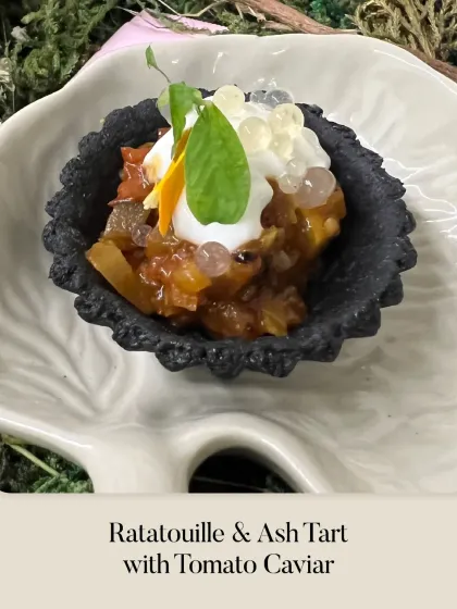 This is my Ratatouille & Ash Tart with Tomato Caviar. The savory ratatouille filling sits in a striking black ash tart shell, topped with creamy foam and glistening tomato pearls.