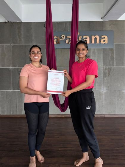 A proud instructor-student moment, celebrating the journey and the accomplishment of becoming a certified teacher.