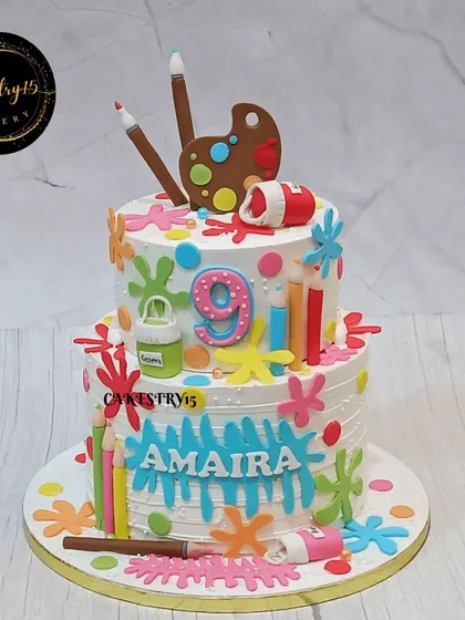A full view of the vibrant artist-themed cake, showing the personalized name and colorful fondant decorations that make this a masterpiece for a young artist.