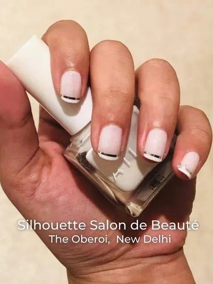 A chic and modern take on the nude nail. This design features a soft, semi-sheer base with a clean, metallic silver line at the cuticle, adding a subtle yet sophisticated detail to a classic look.