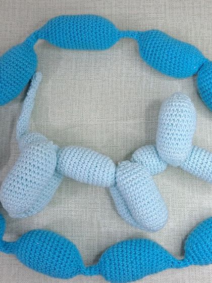 A light blue balloon dog, shown next to an "un-inflated" version.