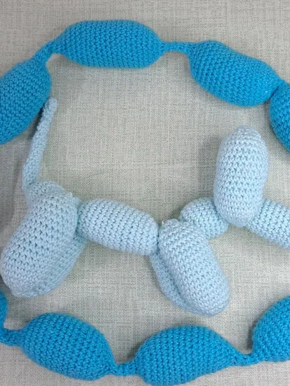 My crochet balloon dogs are a fun and modern addition to any nursery decor. Here are two, one in light blue and one in a darker blue.