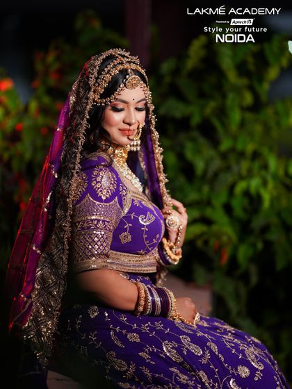 A serene and beautiful shot of the bride, highlighting the detailed embroidery and jewelry that complement the makeup.