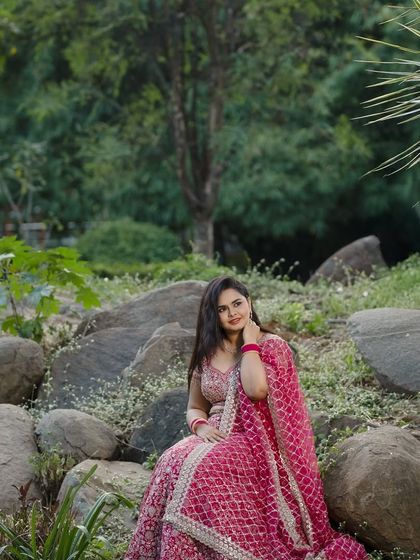 A wider shot of Dr. Meghana's outdoor photoshoot for her ring ceremony. The makeup is designed to look fresh and radiant in a natural setting.