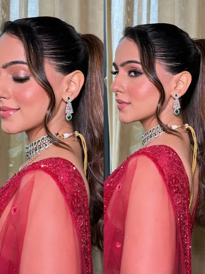 A chic and modern high ponytail with face-framing tendrils. This hairstyle is perfect for a cocktail look, keeping the hair off the face while still looking incredibly stylish.
