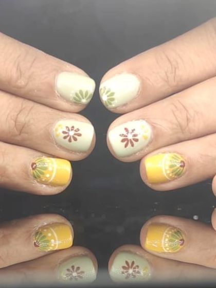 A cute and folksy design with hand-painted floral and fruit-like patterns in yellow, green, and red.