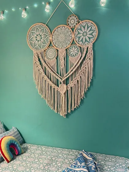A cozy corner made even more special with our macrame dreamcatcher. This large, neutral-toned piece adds texture and a sense of calm, making it the perfect wall art for a relaxing space.