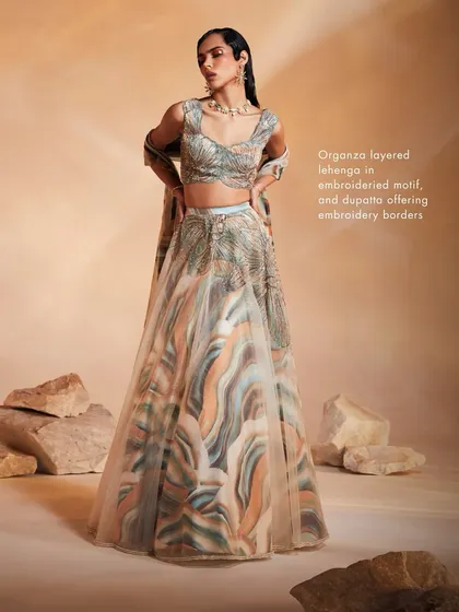This shot of the Ivy Lehenga Set emphasizes the layered organza skirt and embroidered motifs, creating a look of modern, ethereal beauty.